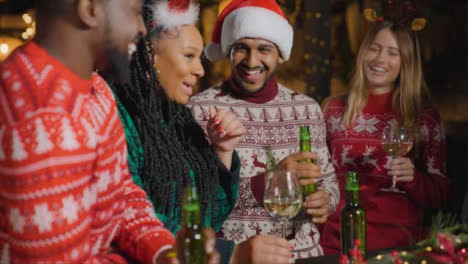 Tracking-Shot-of-Group-of-Friends-Celebrating-Christmas-at-Bar