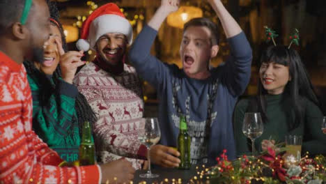 Tracking-Shot-of-a-Drunk-Man-with-His-Friends-During-Christmas-Celebrations-at-Bar