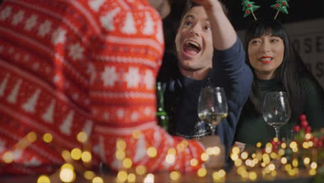 Low-Angle-Shot-of-Drunk-Man-with-His-Friends-During-Christmas-Celebrations-at-a-Bar