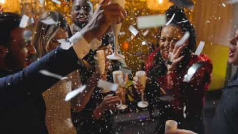 High-Angle-Shot-of-a-Group-of-Friends-Celebrating-New-Years-Eve-with-Confetti