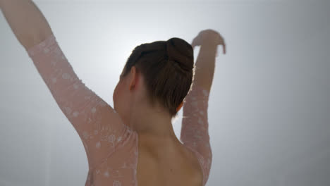 Low-Angle-Shot-of-Ballet-Dancer-Dancing-In-Front-of-Spotlight