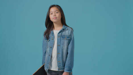 Mid-Shot-of-Little-Boy-Holding-Skateboard-and-Smiling