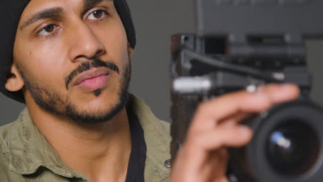 Close-Up-Shot-of-Filmmaker-Getting-His-Camera-Ready
