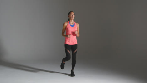 Wide-Shot-of-Young-Woman-Jogging-and-Warming-Up-at-Gym