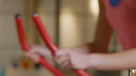 Close-Up-Shot-of-The-Camera-Moving-Towards-Woman-Using-Exercise-Bike