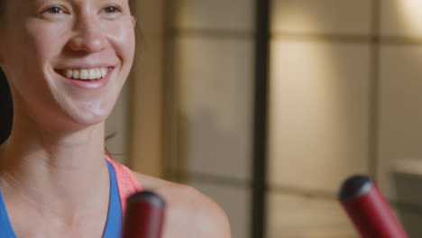 Tracking-Shot-of-a-Woman-Talking-and-Smiling-at-Gym