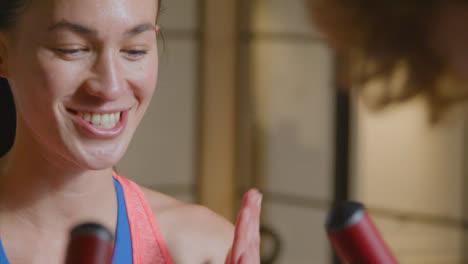 Tracking-Shot-of-a-Woman-Talking-and-Smiling-at-The-Gym