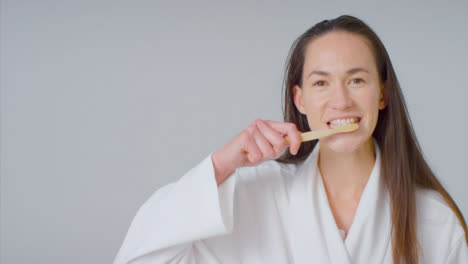 Mid-Shot-of-Young-Woman-Brushing-Her-teeth-with-Copy-Space