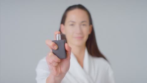 Mid-Shot-of-Woman-Spraying-Perfume