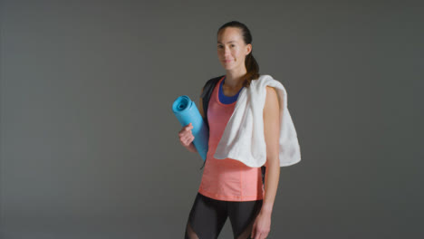Wide-Shot-of-Young-Woman-Carrying-Gym-Stuff