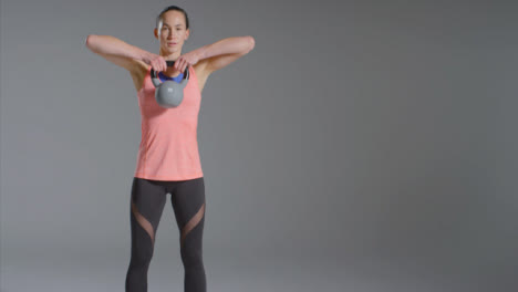 Wide-Shot-of-Woman-Working-Out-with-Kettlebell-with-Copy-Space