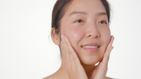 Close-Up-Shot-of-Young-Woman-Blending-Moisturiser-and-Smiling