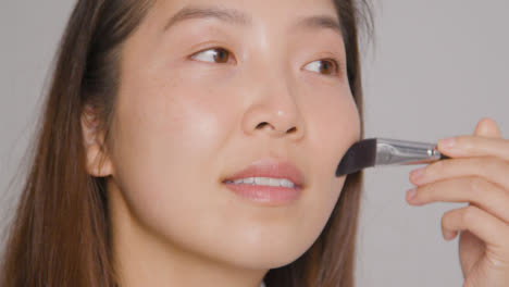 Close-Up-Shot-of-Young-Woman-Applying-Makeup