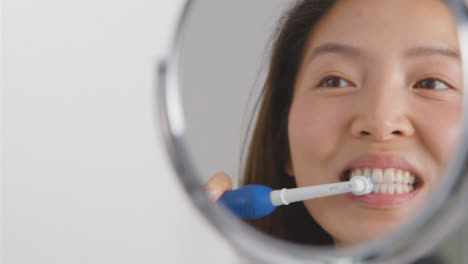Close-Up-Shot-of-Young-Woman-Brushing-Teeth