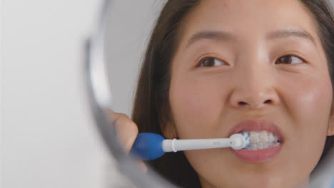 Close-Up-Shot-of-a-Young-Woman-Brushing-Teeth