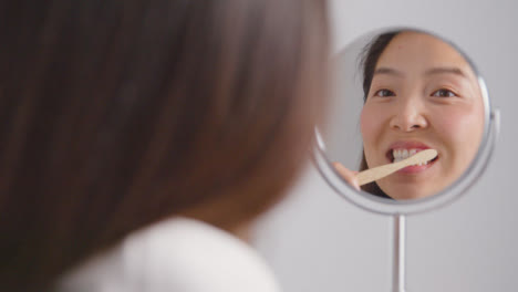 Mid-Shot-of-a-Young-Woman-Brushing-Teeth