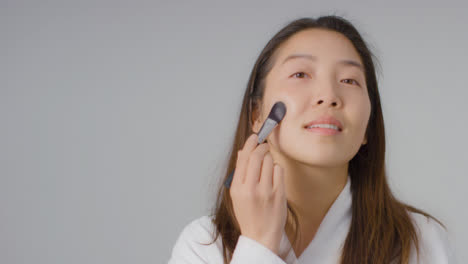 Mid-Shot-of-Woman-Applying-Foundation-with-Copy-Space