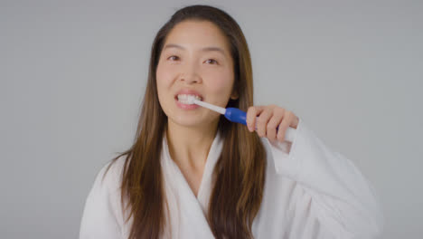 Mid-Shot-of-a-Young-Woman-Brushing-Her-Teeth