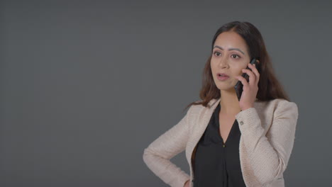 Mid-Shot-of-Woman-Talking-on-Phone-Annoyed