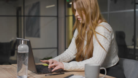 Mid-Shot-of-Young-Woman-Typing-on-Computer