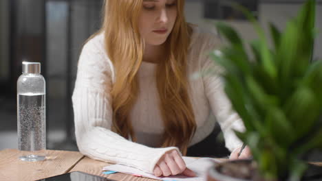 Mid-Shot-of-Young-Woman-Writing