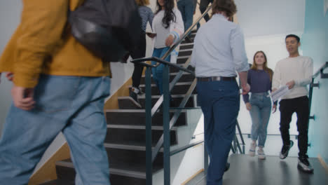 Low-Angle-Shot-of-Students-Walking-In-Stairwell-
