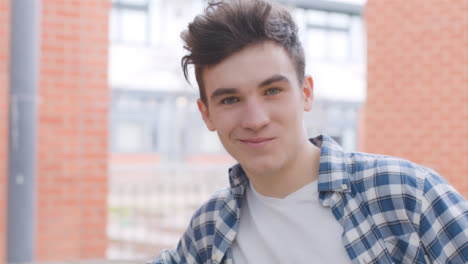 Portrait-Shot-of-a-Young-Man-In-Front-of-a-Brick-Wall