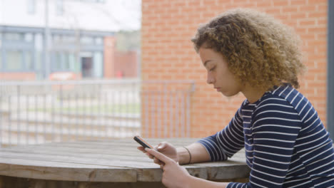 Medium-Shot-of-Young-Woman-In-Front-of-Brick-Wall