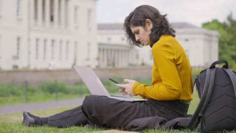 Mid-Shot-of-Female-Student-Using-Laptop-in-Campus-Park