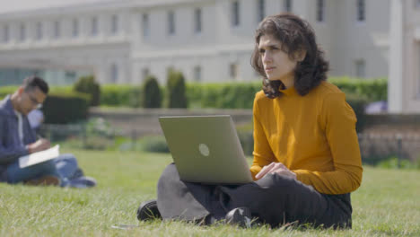 Tracking-Shot-of-a-Female-Student-Using-Laptop-in-College-Park