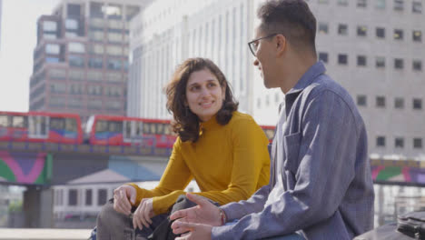 Mid-Shot-of-Two-Students-Talking-and-Smiling-with-City-Backdrop