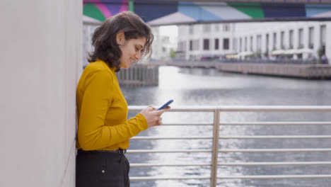 Tracking-Shot-of-Young-Woman-Talking-On-Smartphone