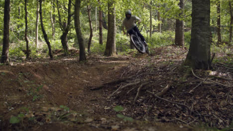 Man-On-Mountain-Bike-Cycling-Along-Dirt-Trail-Through-Woodland-At-Speed-2