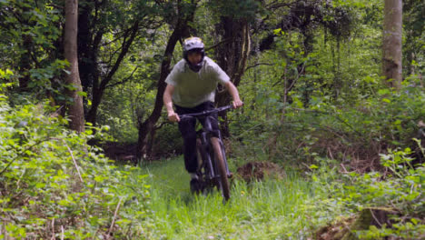 Slow-Motion-Shot-Of-Man-On-Mountain-Bike-Making-Mid-Air-Jump-On-Dirt-Trail-Through-Woodland-11