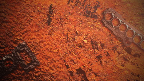 Spaceship-elements-on-orange-ground-of-planet-in-galaxy