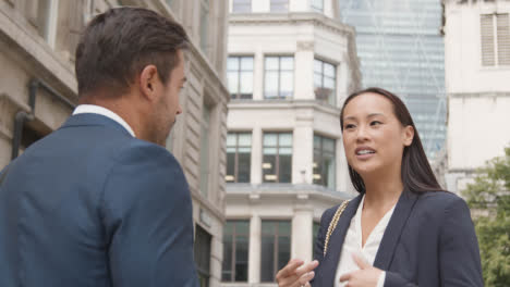 Businessman-And-Businesswoman-Having-Informal-Meeting-Outside-Office-3