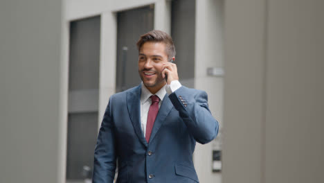 Businessman-Outside-Office-Taking-Call-On-Mobile-Phone-3