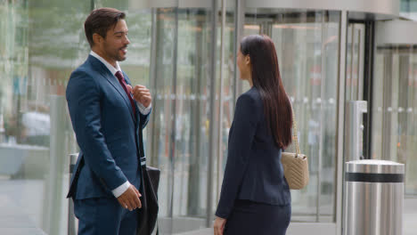 Businessman-And-Businesswoman-Having-Informal-Meeting-Outside-Office-4