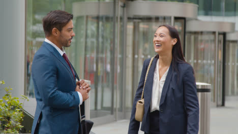 Businessman-And-Businesswoman-Having-Informal-Meeting-Outside-Office-5