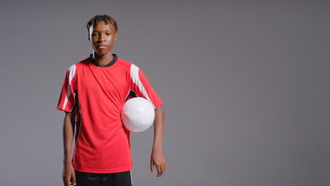 Studio-Portrait-Of-Young-Male-Footballer-Wearing-Club-Kit-With-Ball-Under-Arm-3