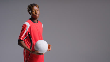 Studio-Portrait-Of-Young-Male-Footballer-Wearing-Club-Kit-With-Ball-Under-Arm-4