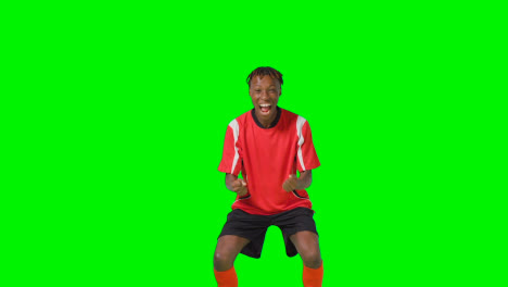 Portrait-Of-Young-Male-Footballer-Wearing-Club-Kit-Celebrating-Goal-Against-Green-Screen-3