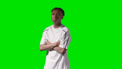 Studio-Portrait-Of-Young-Male-Footballer-Or-Sportsperson-Wearing-Club-Kit-Against-Green-Screen-2