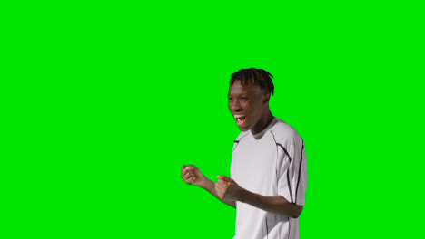 Portrait-Of-Young-Male-Footballer-Wearing-Club-Kit-Celebrating-Goal-Against-Green-Screen-5