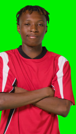 Vertical-Video-Studio-Portrait-Of-Young-Male-Footballer-Wearing-Club-Kit-Against-Green-Screen-1