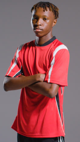 Vertical-Video-Studio-Portrait-Of-Young-Male-Footballer-Wearing-Club-Kit-1