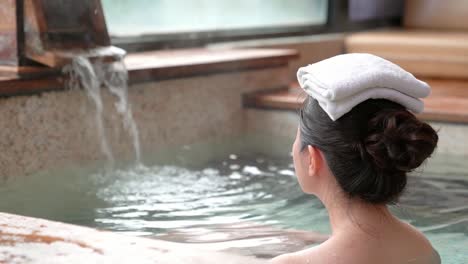 rear-view-of-young-girl-enjoy-the-hot-springs