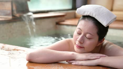 girl-lying-down-on-poolside-and-put-a-towel