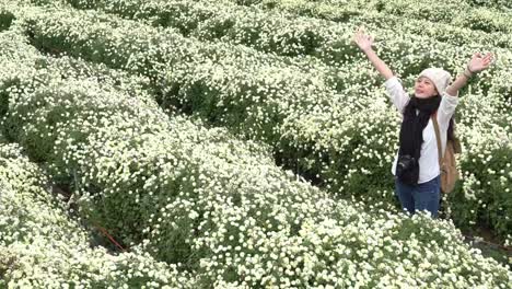 Carefree-asian-in-the-daisies-field-in-autumn