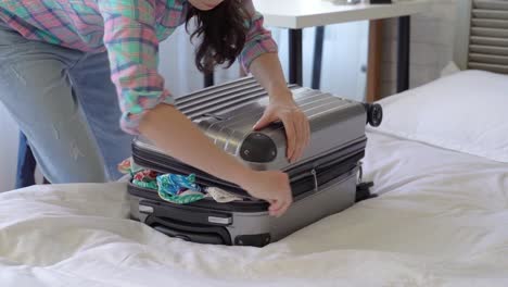 woman-squeezing-and-dragging-the-suitcase